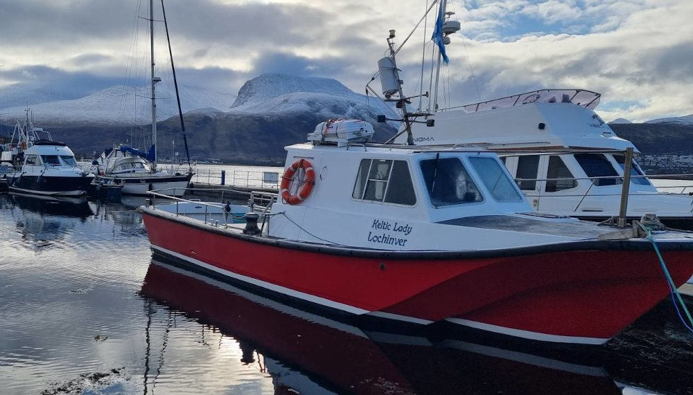 Keltic Lady in Corpach marina with a snowy Ben Nevis in the background